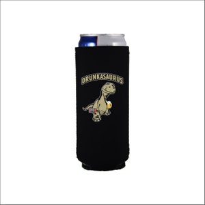 May include: Black neoprene can cooler with a cartoon dinosaur holding a beer and the text "Drunkasaurus".