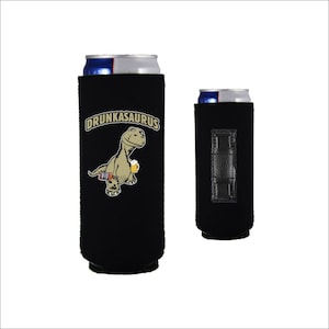 May include: Black neoprene can cooler with a cartoon dinosaur holding a beer and the text "DRUNKASAURUS".