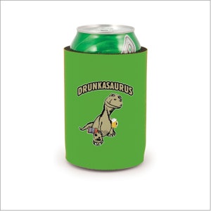 May include: A green can cooler with the word "DRUNKASAURUS" above a cartoon dinosaur holding a beer mug and a camera. A green can is inside the cooler.