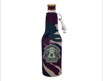 May include: A camouflage-patterned beer bottle cooler with a built-in bottle opener. The cooler features the text "Weekend Forecast: Drinking with a chance of Camping" and a green tent icon.