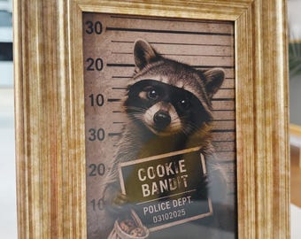 Mugshot portrait of a cute whimsy unique racoon called Cookie Bandit in sepia style in gold frame
