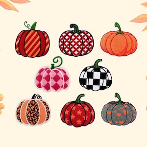 May include: A collection of eight embroidered pumpkin patches featuring various patterns including red stripes, red and white lattice, solid orange, pink plaid, black and white checkerboard, orange leopard print, red stars, and gray with orange hearts.