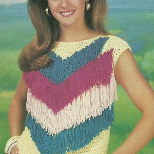 May include: A yellow crochet top with a V-shaped design featuring layers of blue, pink, and white fringe.