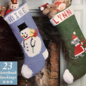 May include: Two Christmas stockings, one blue with a snowman design and the name "MIKE", the other green with a mouse in a Santa suit and the name "LYNN". Both are filled with toys. The text "23 Storybook Stockings" is visible.
