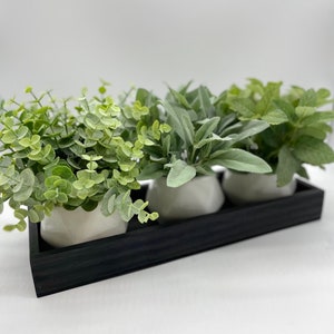 May include: A set of three ceramic mugs with a speckled, matte finish. The mugs are in shades of cream, light gray, and dark gray. Each mug has a simple, minimalist design, perfect for coffee or tea.