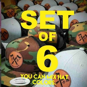 May include: Set of six trucker hats in various colors, including camouflage, gray, and black. The hats feature a brown leather patch with an axe design and the text "workingRB". The text "SET OF 6 YOU CAN MIX HAT COLORS." is displayed in yellow.
