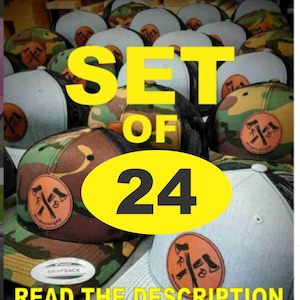 May include: A set of 24 camouflage and gray trucker hats with a brown leather patch featuring crossed axes. The hats have black mesh back panels and the text "SET OF 24" and "READ THE DESCRIPTION" are visible in the image.