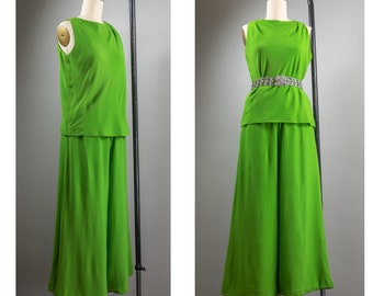 May include: A lime green two-piece outfit with a sleeveless top and wide-legged pants. The outfit is on a mannequin and has a silver belt.