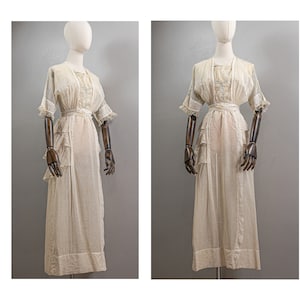 May include: A white cotton dress with a ruffled skirt and short sleeves. The dress has a simple design and is made of a lightweight fabric.