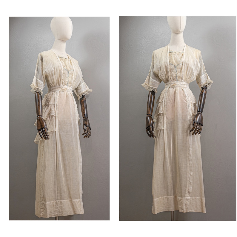 May include: A white cotton dress with a ruffled skirt and short sleeves. The dress has a simple design and is made of a lightweight fabric.
