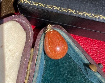 Sparkly goldstone egg pendant