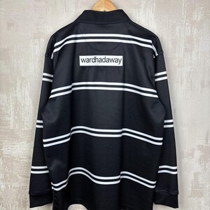 May include: Black long-sleeve shirt with white horizontal stripes. The shirt features a collared neckline and the text "wardhadaway" on the back. The shirt is hanging from a wooden hanger.