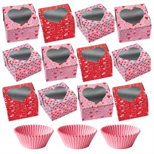 May include: Twelve pink and red heart-shaped cupcake boxes with clear windows, and three pink cupcake liners.
