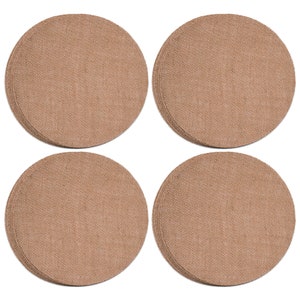 May include: Set of four round brown woven placemats. The placemats are made of a natural material and have a textured surface.