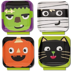 May include: A set of four square paper plates featuring Halloween character designs. The plates display a green Frankenstein monster, a white mummy with black bandages, an orange jack-o'-lantern, and a black cat with gold whiskers.