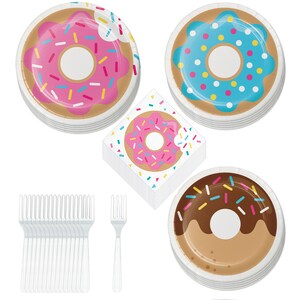 May include: A set of donut-themed party supplies, including pink, blue, and brown paper plates with donut designs, white plastic forks, and a stack of napkins with a pink donut design.