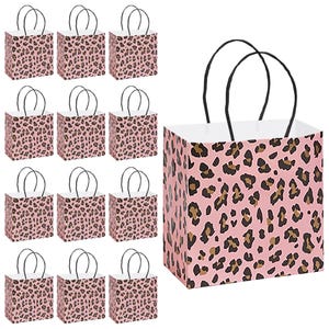 May include: A collection of pink gift bags with a leopard print pattern. Each bag has black handles and a white interior. The bags are square-shaped and suitable for various occasions.