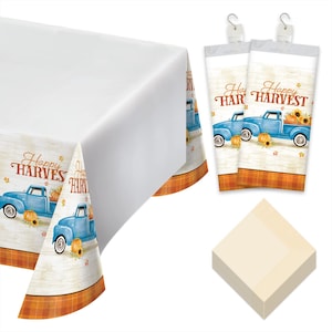 May include: A white tablecloth with a decorative border featuring a blue truck carrying pumpkins and sunflowers, with the text "Happy Harvest". Includes matching napkins and two rolls of plastic cutlery.