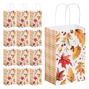 May include: Set of 12 small paper gift bags with a fall leaf design. The bags have white handles and are decorated with a plaid pattern on the side. The bags are perfect for small gifts or favors.