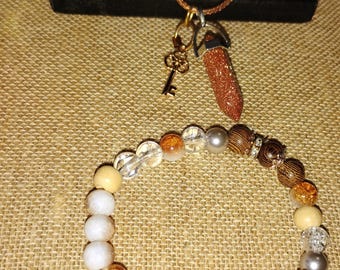 Conjunto de collar con punta de cristal y pulsera de cuentas