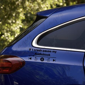 May include: A blue car with a black decal that reads "If I crash pause my Audiobook" with media control icons. The car's taillight is visible.