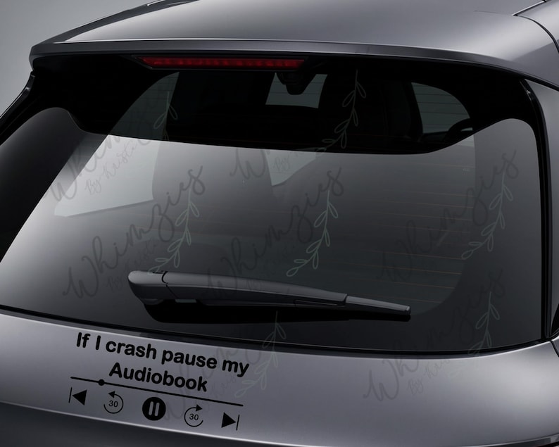 May include: Black car decal with the text "If I crash pause my Audiobook" and a media player control graphic. The decal is applied to the rear window of a vehicle.