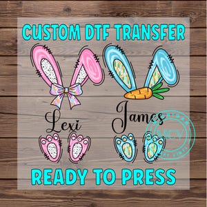 May include: Custom DTF transfer with two bunny ears, one pink and one blue, with a bow and carrot. The names Lexi and James are written below the ears. Two sets of bunny feet are below the names. The text "READY TO PRESS" is at the bottom of the image.