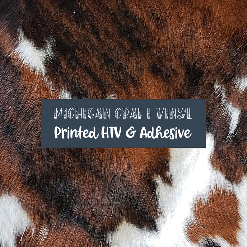 May include: Close-up of a brown, black, and white cowhide pattern. The text "MICHIGAN CRAFT VINYL Printed HTV & Adhesive" is displayed on a dark blue background.