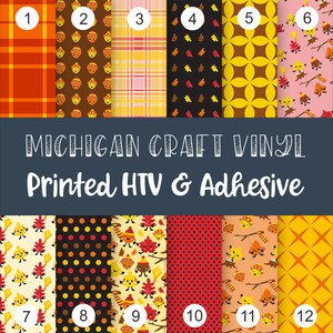 May include: A selection of printed HTV and adhesive vinyl sheets with various fall-themed patterns. Designs include plaid, acorns, leaves, and polka dots in shades of orange, brown, yellow, and black. The text "MICHIGAN CRAFT VINYL Printed HTV & Adhesive" is displayed.
