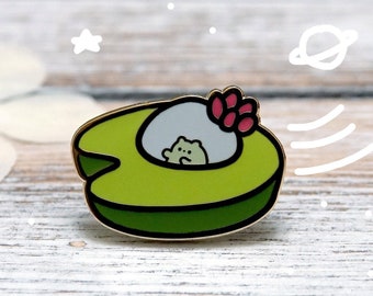 May include: A green avocado-shaped spaceship with a white interior and a pink flower on top. A small white creature with pink ears is inside the spaceship.