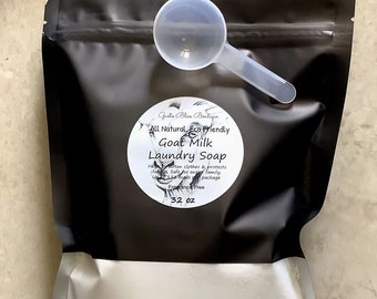 May include: A black resealable bag with a white label that says "Goat Milk Laundry Soap" and "All Natural Eco Friendly". The bag contains a white powder and a white plastic scoop.