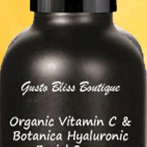 May include: A black glass bottle with a white label that reads "Gusto Bliss Boutique Organic Vitamin C & Botanica Hyaluronic Facial Serum" with a list of ingredients and "10% Solution 1 oz".