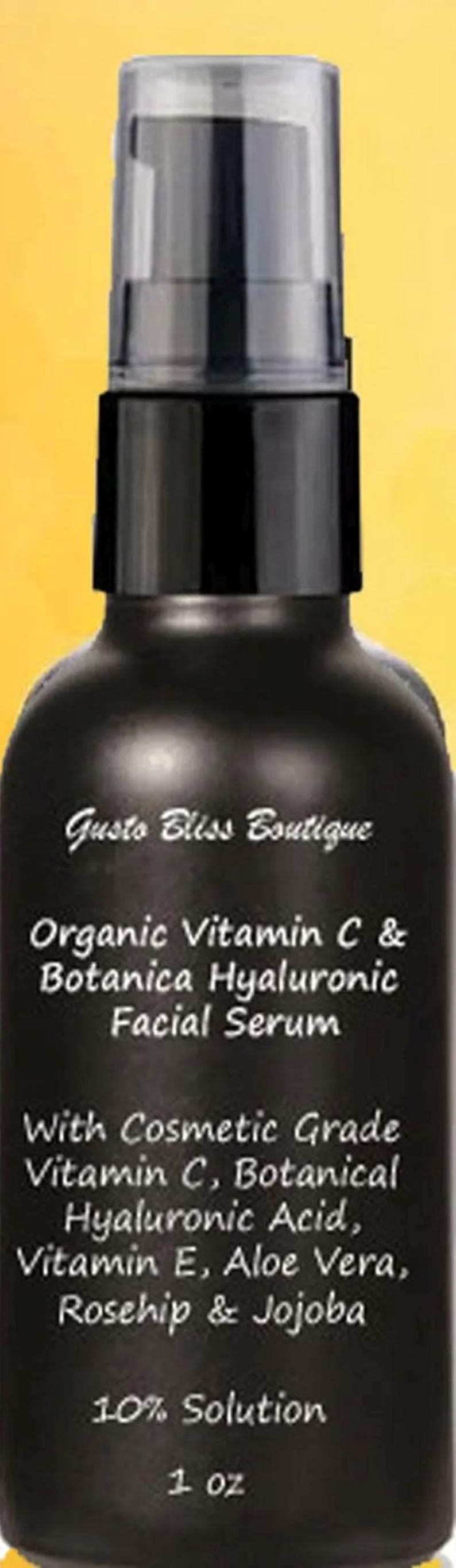 May include: A black glass bottle with a white label that reads "Gusto Bliss Boutique Organic Vitamin C & Botanica Hyaluronic Facial Serum" with a list of ingredients and "10% Solution 1 oz".