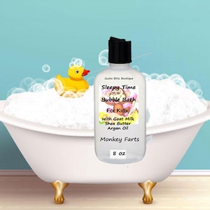 May include: A clear bottle of "Sleepy Time Bubble Bath For Kids" with a black cap, sitting in a white bathtub filled with bubbles. A yellow rubber duck floats in the bubbles. The bottle contains 8 oz of product.