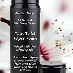 May include: A black bottle with a pump dispenser labeled "Tush Toilet Paper Foam" with the text "All Natural Effectively Cleans" and "Infused with skin softening oils."  The bottle also includes instructions for use and the size "2 oz".
