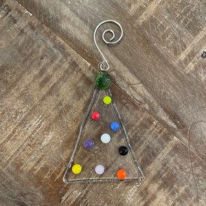 Clear Christmas tree ornament with multi color decorations
