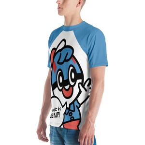 May include: A white and blue raglan t-shirt featuring a cartoon character with a blue and red design. The character has a speech bubble with text. The sleeves are light blue.