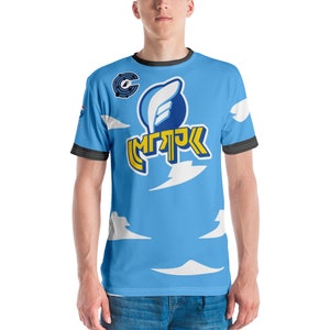 May include: A blue t-shirt with a white cloud pattern and a yellow logo that says "MGPK". The logo features a blue and white wing design.