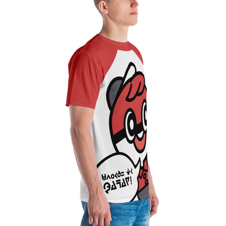 May include: A white and red baseball tee featuring a cartoon character with a red and black design. The character has large eyes and a speech bubble with text. The sleeves are red.