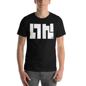 May include: Black t-shirt with a white graphic design that reads "LNH!" in bold, block letters. The design includes a small circular logo. The shirt is short-sleeved and appears to be made of a soft material.