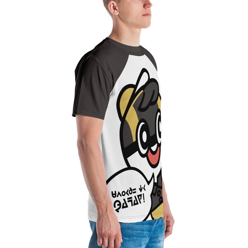 May include: A black and white t-shirt with a cartoon character wearing a hat and glasses. The character is saying "YAKSO = GOOD!" in a speech bubble.