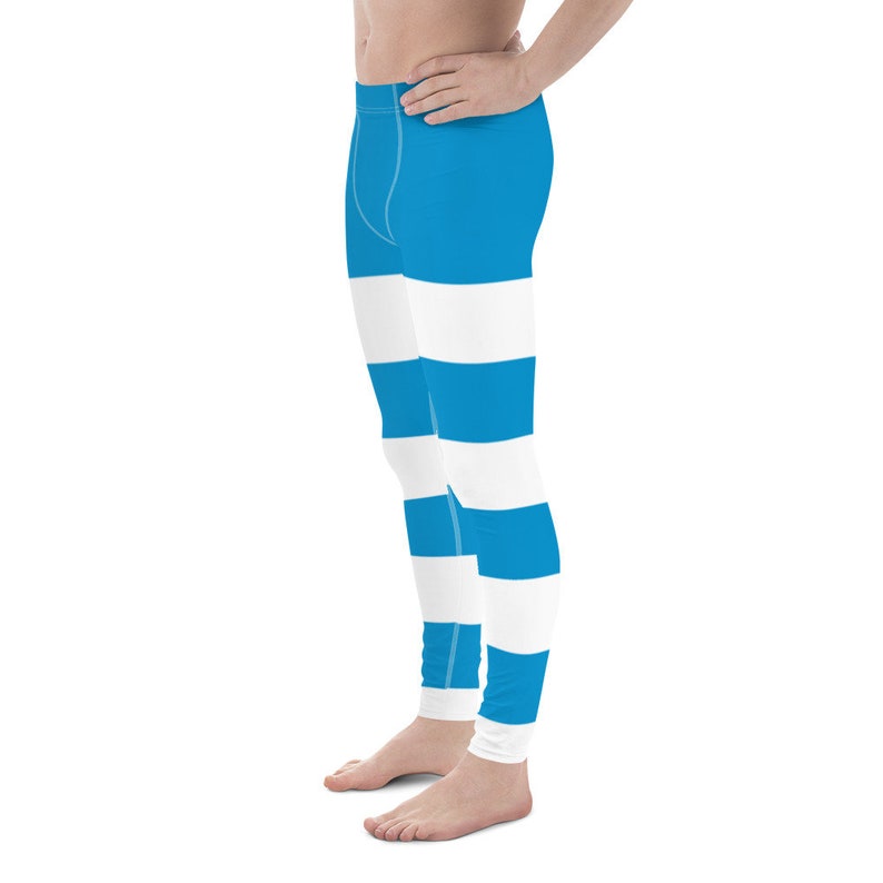 May include: Blue and white striped leggings. The leggings have a wide horizontal stripe pattern.