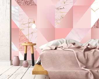 May include: A wall mural featuring a geometric pattern of pink, white, and rose gold glitter triangles alongside marble-textured sections. The design includes a wooden side table with a lamp, two small textured vases, and a bed with pink bedding.