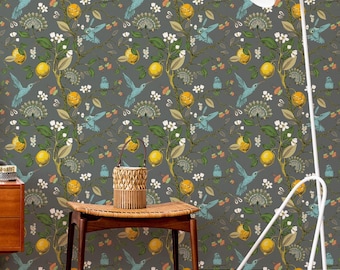 May include: Wallpaper featuring a repeating pattern of yellow lemons, green leaves, white blossoms, and light blue hummingbirds on a dark gray background. A wooden stool with a woven basket sits in front of the wall, next to a white floor lamp.