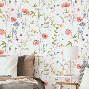 May include: Wallpaper featuring a watercolour botanical pattern on a white background. The design includes scattered coral-pink poppies, small blue hydrangea clusters, and delicate green foliage with thin stems and leaves across the surface.