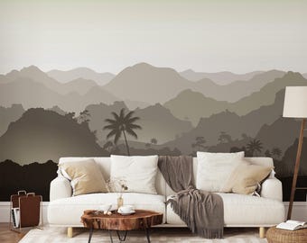 May include: A wall mural featuring a layered mountain landscape in shades of beige, taupe, and dark brown. The design depicts silhouettes of rolling hills, palm trees, and dense foliage, creating a gradient effect from light to dark tones.