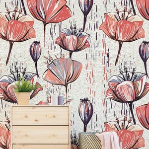 May include: Wallpaper featuring a repeating pattern of stylized coral-pink and grey flowers with dark outlines on a textured off-white background, interspersed with vertical dashes in shades of grey and coral-pink, set behind a light wood dresser.