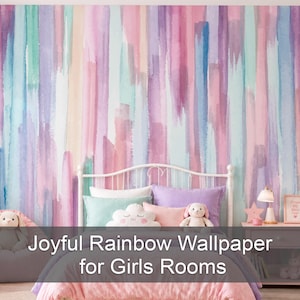 May include: A wall mural featuring vertical watercolour brushstrokes in shades of pink, purple, blue, and mint green. The text Joyful Rainbow Wallpaper for Girls Rooms is overlaid on the image. The wallpaper serves as a backdrop for a bed.