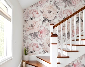 May include: Wallpaper featuring a repeating pattern of large, soft pink watercolor roses and dark gray leaves on a white background, applied to a wall beside a staircase with wooden treads, white risers, and a white railing with a wooden handrail.