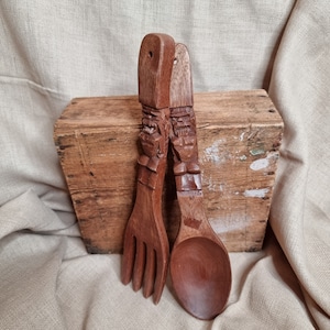 Vintage 1970s carved monkey pod fork & spoon wall set with carved handles.